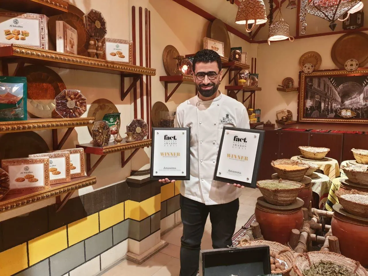 Chef Rami holding the FACT Dining Awards for Amaseena